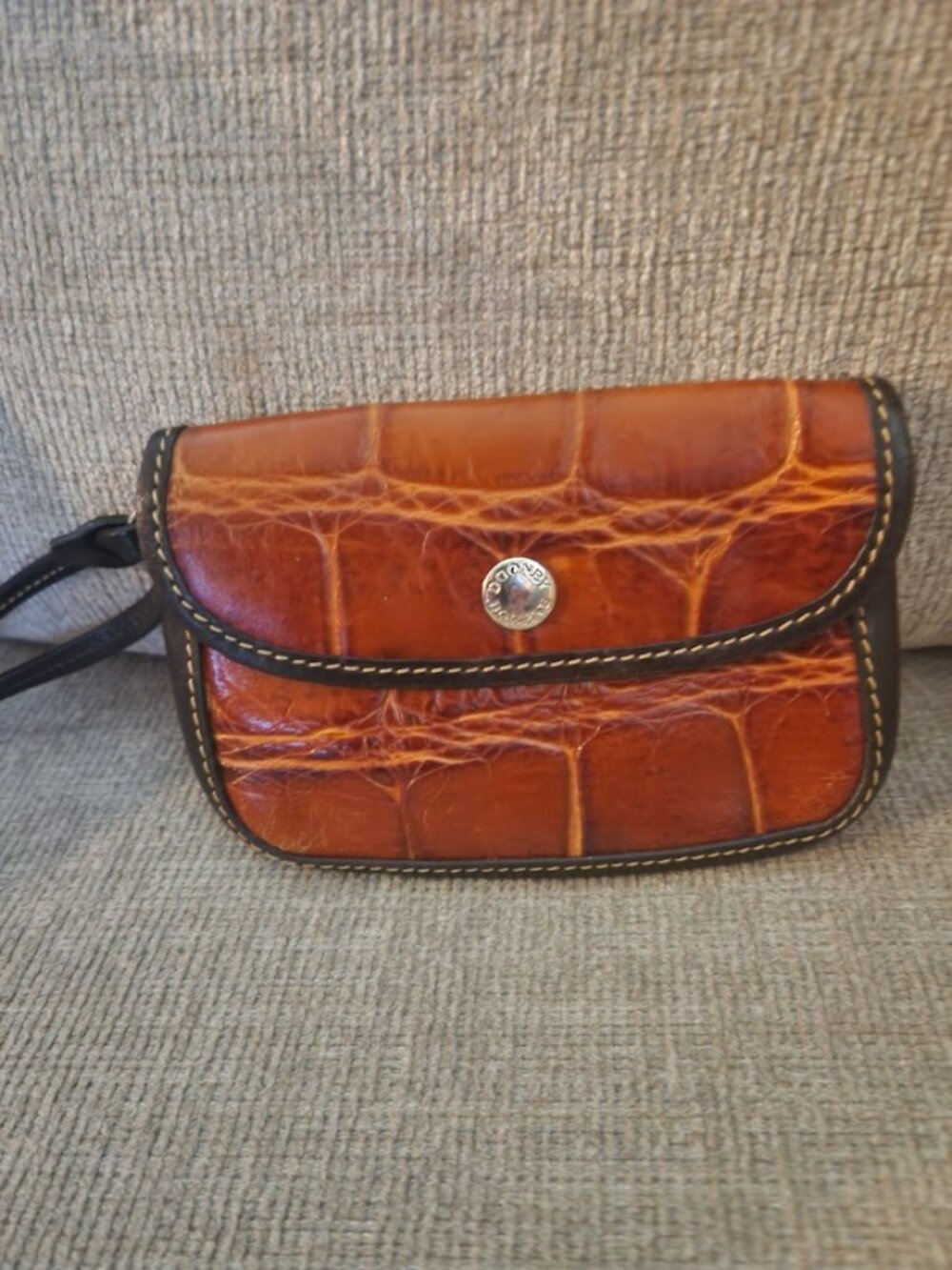 this a vintage Dooney Bourke croc embossed leather wristlet
